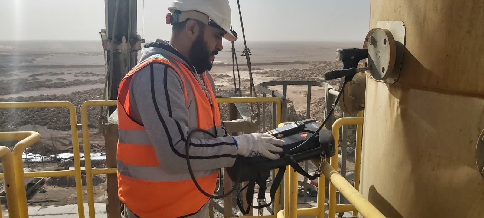 Field engineer conducting emissions monitoring at industrial facility