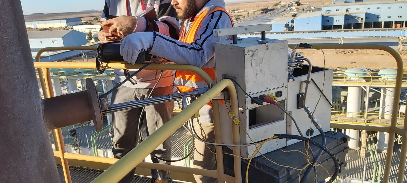 Team conducting stack emissions testing at industrial site