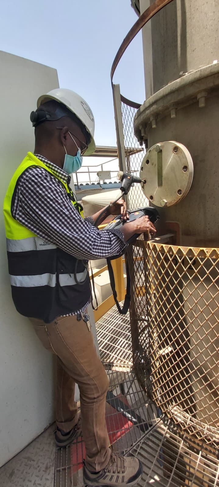 Technician performing gas analysis at industrial site