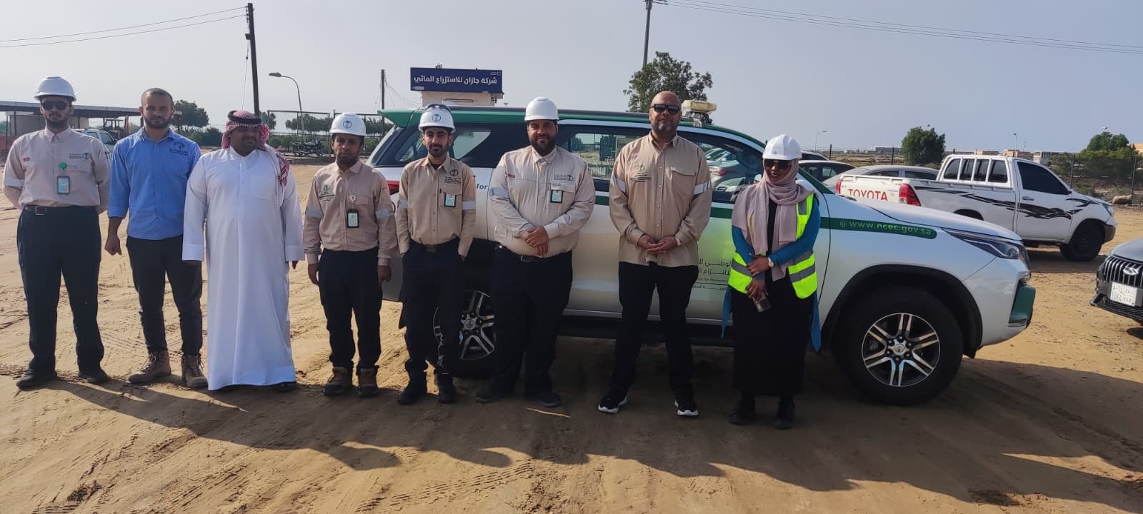 Environmental compliance team with NCEC vehicle at field site